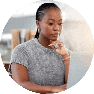 Focused woman working on laptop for healthcare or telehealth services.