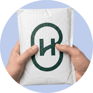 Person holding Harbor Health branded package for health services.